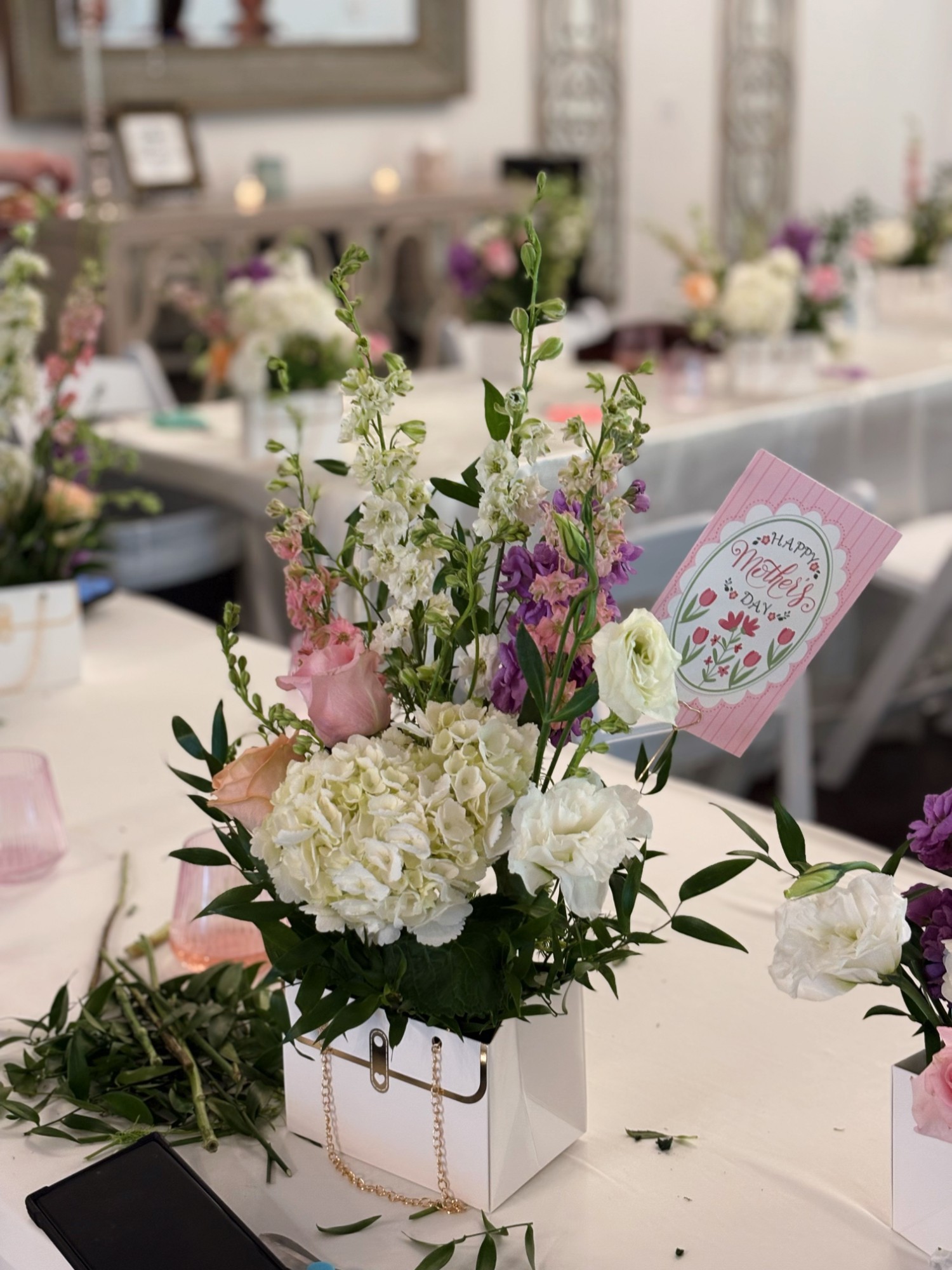 Table of finished floral centerpieces from a class