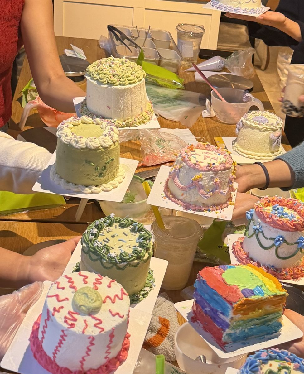 Students showing their piped vintage-style mini cakes